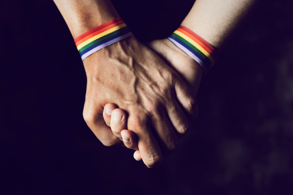 holding hands with rainbow bracelets